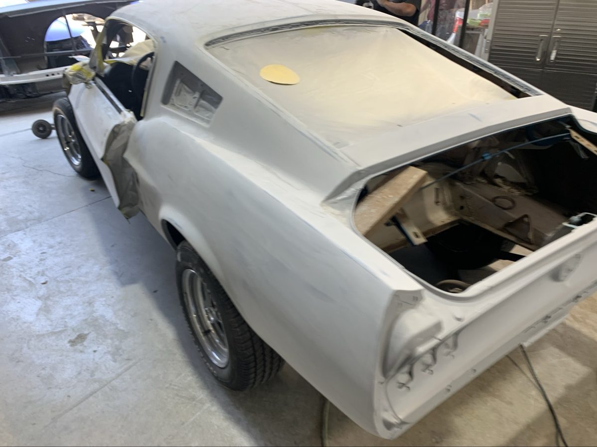 Classic Ford Mustang in primer before full repaint at Crown Auto Body