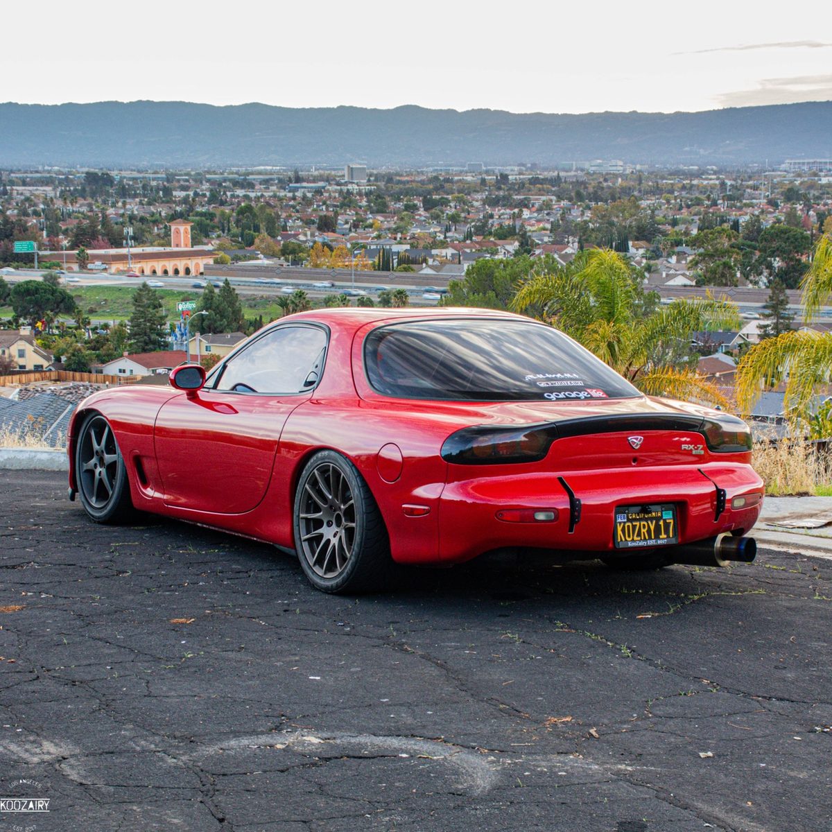 Mazda RX-7 stock body rear view before widebody transformation at Crown Auto Body